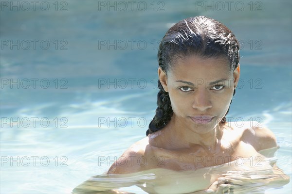 Nude mixed race woman in swimming pool