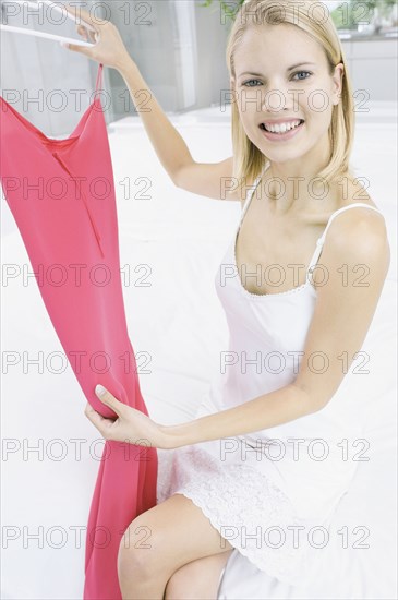 Smiling woman admiring dress