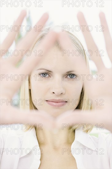 Woman framing her face with hands