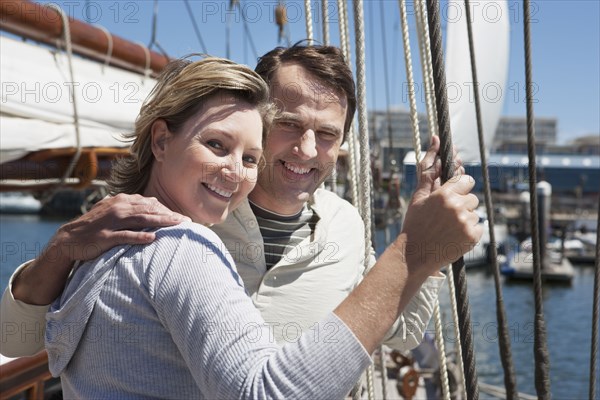 Caucasian couple smiling on sailboat