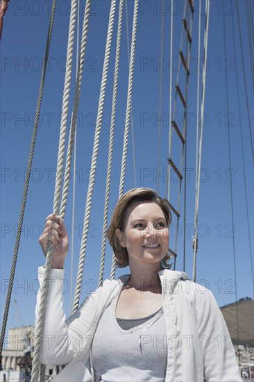 Caucasian woman smiling on sailboat