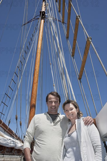 Caucasian couple smiling on sailboat