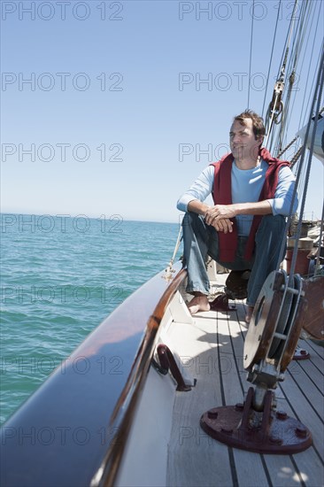 Caucasian man relaxing on sailboat