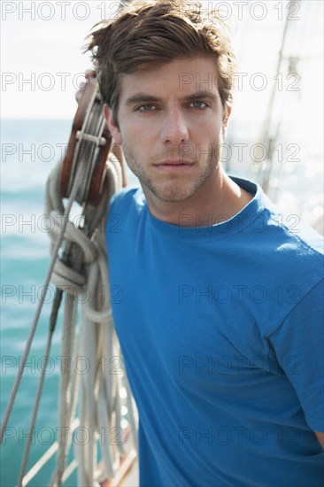 Caucasian man standing on sailboat