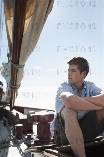 Caucasian man relaxing on sailboat