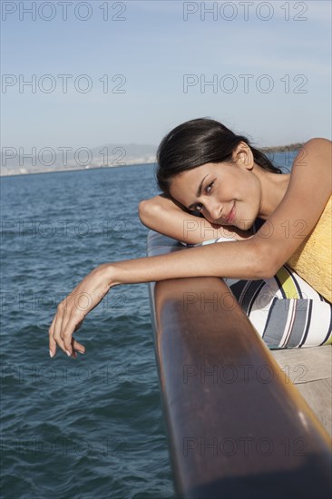 Caucasian woman relaxing on sailboat