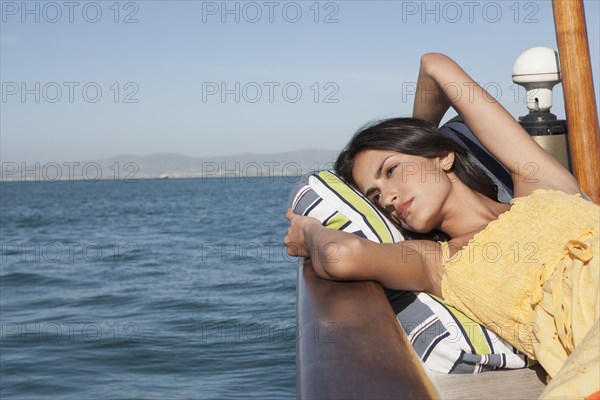 Caucasian woman relaxing on sailboat