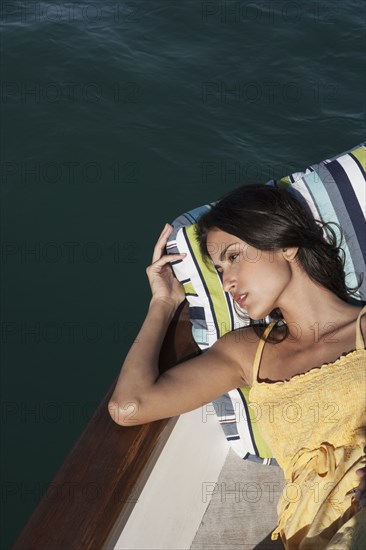 Caucasian woman relaxing on sailboat