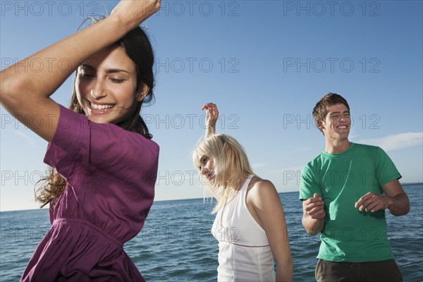 Caucasian friends dancing on sailboat