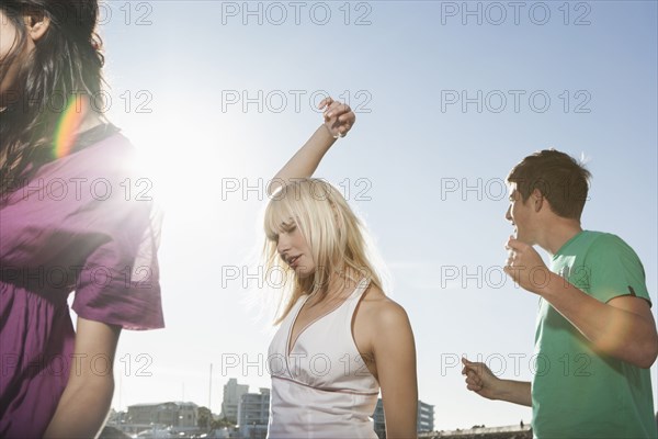 Caucasian friends dancing outdoors