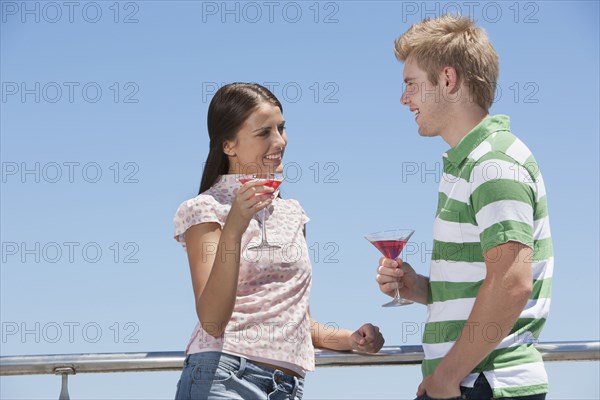 Caucasian couple enjoying cocktails outdoors