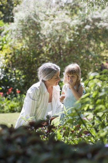 Grandmother and granddaughter in garden