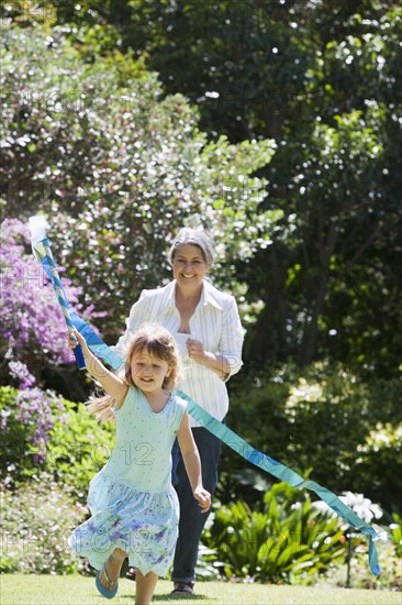 Grandmother and granddaughter playing in garden