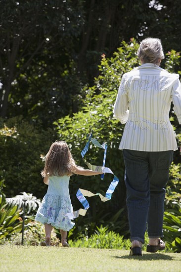 Senior Caucasian woman and granddaughter playing outdoors
