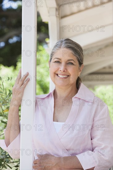 Senior Caucasian woman standing on porch