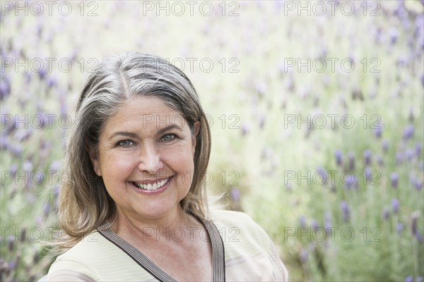 Caucasian woman smiling in lavender field