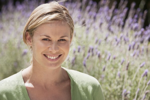 Caucasian woman smiling in lavender field