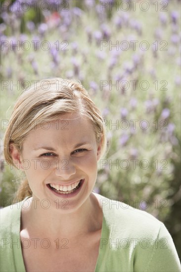 Caucasian woman smiling in lavender field