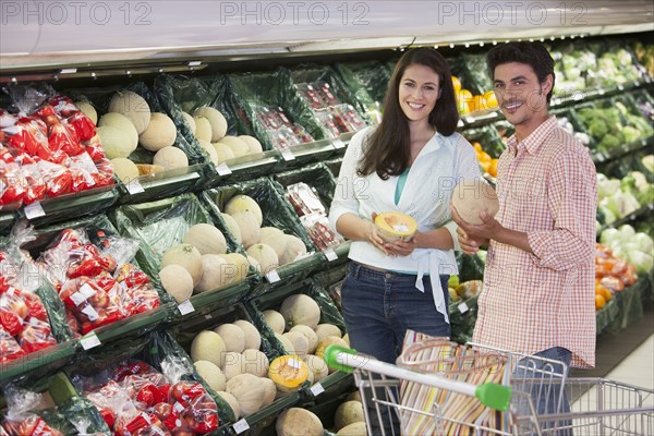 Caucasian couple shopping in grocery store