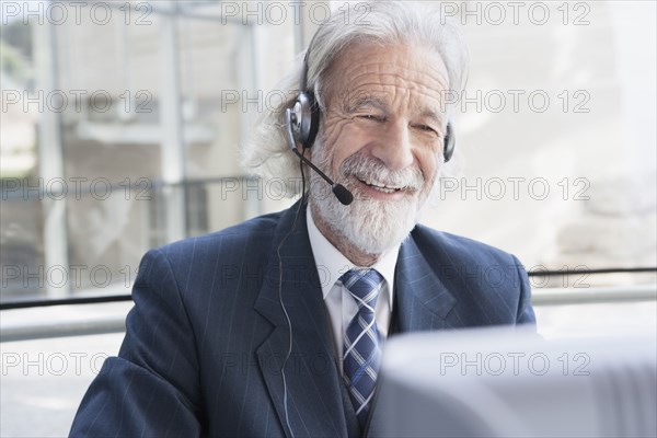 Senior Caucasian businessman talking on headset