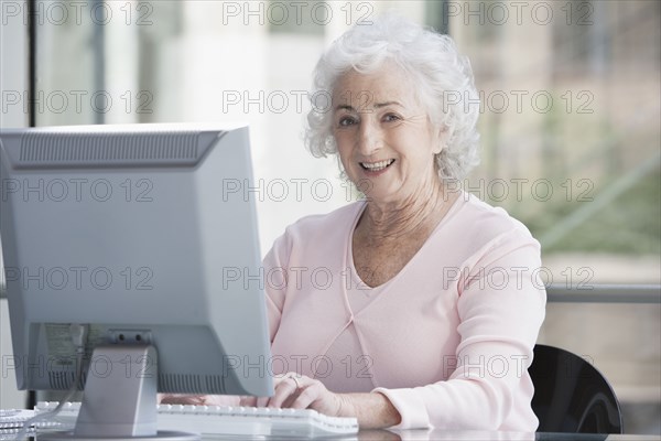 Senior Caucasian businesswoman working at desk