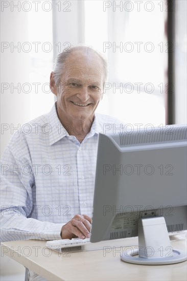 Senior Caucasian businessman working at desk