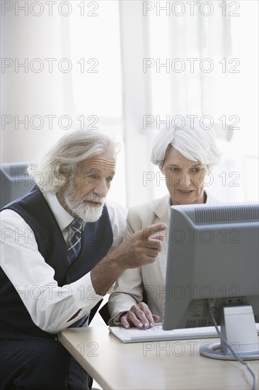 Senior Caucasian business people working together in office