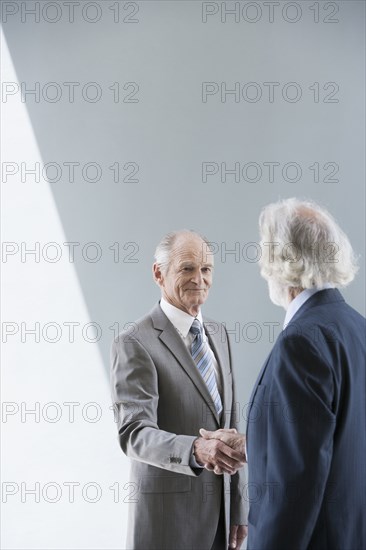 Senior Caucasian businessmen shaking hands