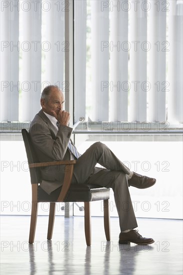 Senior Caucasian businessman sitting in chair