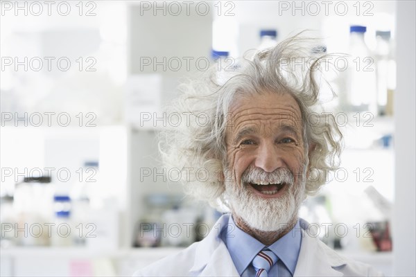 Senior Caucasian scientist with unruly hair in lab