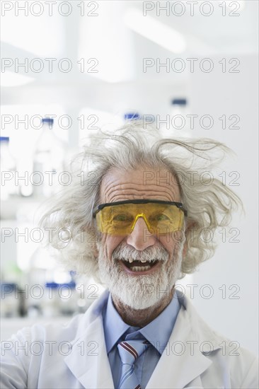 Senior Caucasian scientist with unruly hair in lab