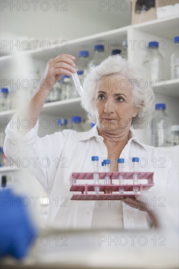 Senior Caucasian scientist examining samples in lab