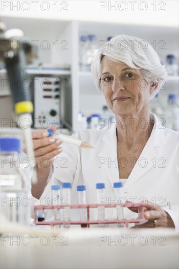 Senior Caucasian scientist testing samples in lab