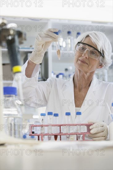 Senior Caucasian scientist examining samples in lab