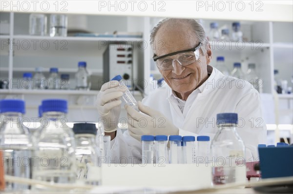 Senior Caucasian scientist examining samples in lab