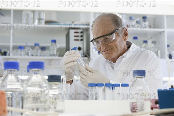 Senior Caucasian scientist examining samples in lab