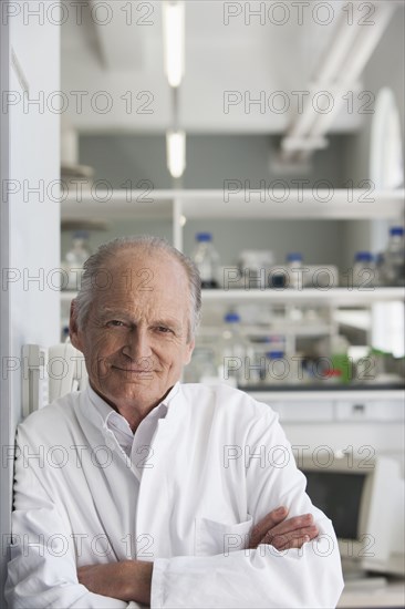 Senior Caucasian scientist smiling in lab