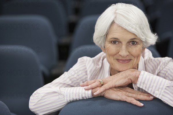 Senior Caucasian woman smiling in lecture hall