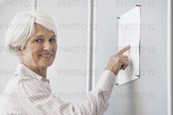 Senior Caucasian woman reading sign