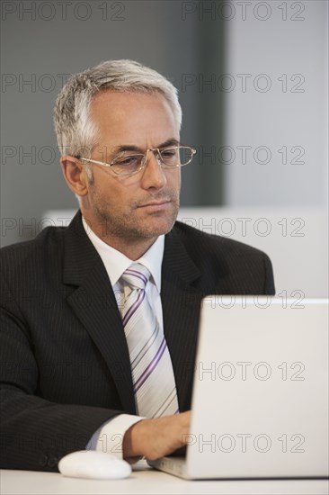 Businessman working at desk in office