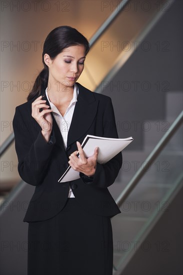 Businesswoman taking notes in office