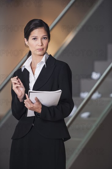 Businesswoman taking notes in office