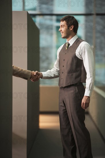 Businessmen shaking hands in office