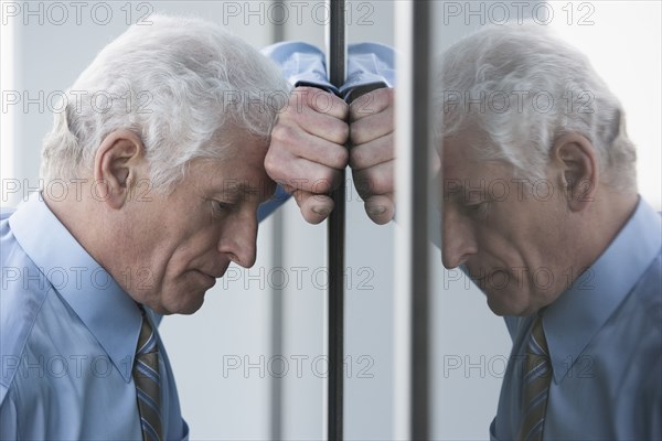 Caucasian businessman leaning on window