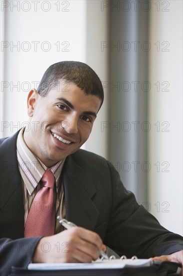 Hispanic businessman working in office