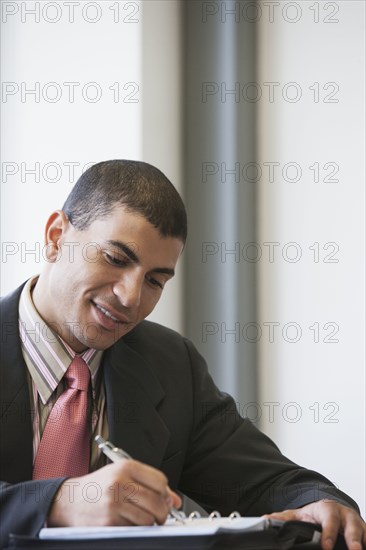 Hispanic businessman working in office