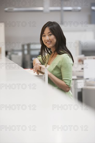 Asian businesswoman smiling in office
