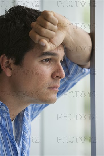 Man looking out window