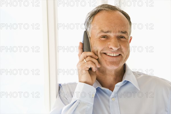 Businessman talking on phone in office