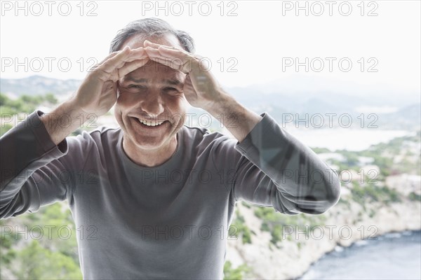 Man peering through window